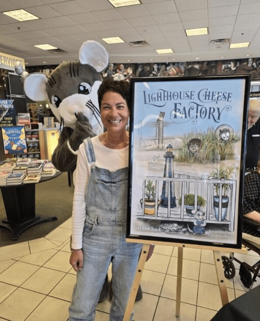 A woman holding a mouse and a poster